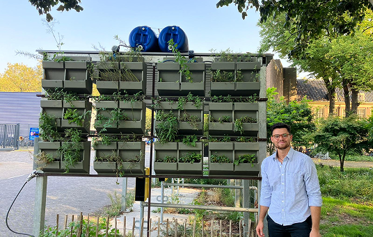 Muuras Wetland Wall prototype installed outdoors with a team member beside it